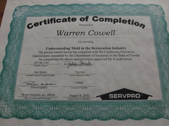 Certificate of completion for Warren Cowell in mold restoration, with SERVPRO logo and signatures